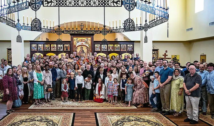 Parish photo in front of the iconostasis with their clergy