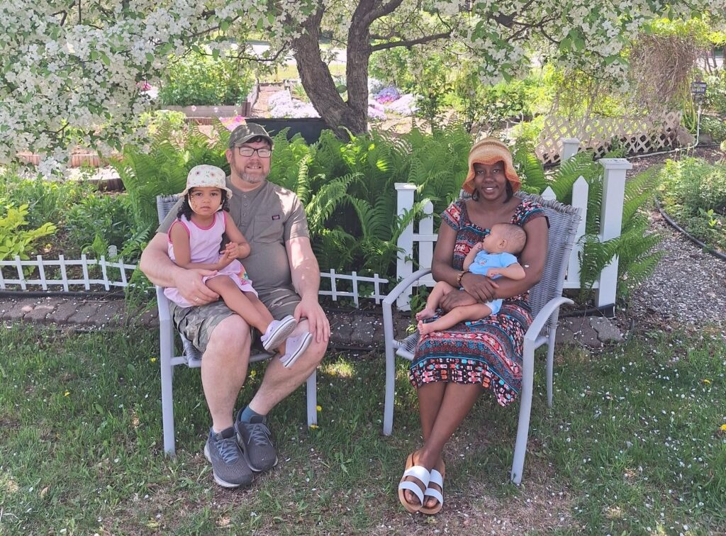 The Tweten family seated together in the garden