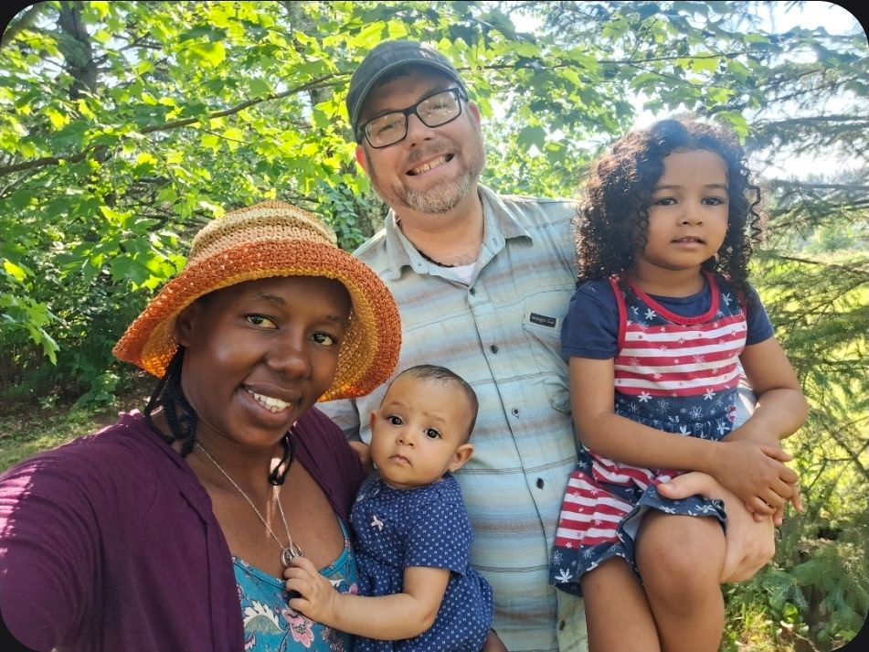 Eric and Mary Tweten outdoors with their two daughters